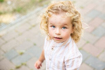 Handsome boy with blue eyes and curly blond hair