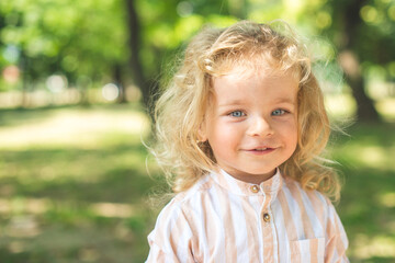 Handsome boy with blue eyes and curly blond hair
