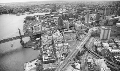 Fototapeta premium Brooklyn and Manhattan Bridges aerial view from helicopter, New York City. City skyline from a high vantage point - NY - USA.
