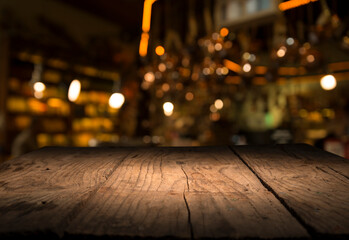 Empty dark wooden table in front of abstract blurred bokeh background of restaurant . can be used...