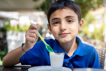 little kid boy, laughing and eating ice cream sicilian Granita