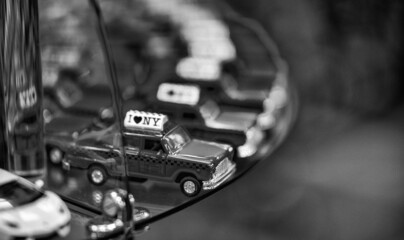 Fototapeta na wymiar Row of miniature New York Old Taxis in a city shop. New York City transportation concept.