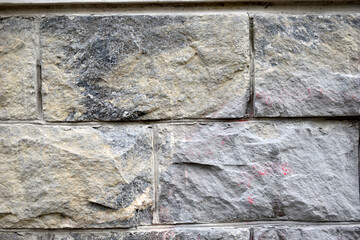 The wall is made of gray granite stone