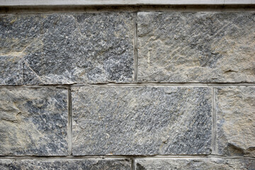 The wall is made of gray granite stone