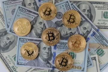Coins of Bitcoin and one hundred dollars USA. Money concept.