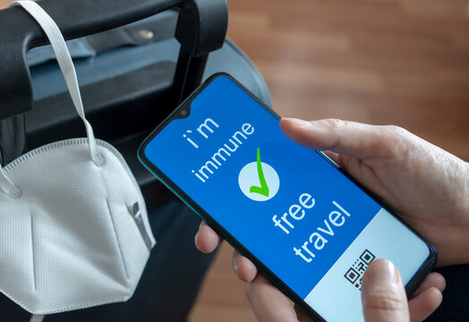 Immunity passport, risk-free certificate concept. A hand in medical gloves holds a passport marked with the outbreak of the coronavirus COVID-19, travel after the pandemic to travel freely repirastor