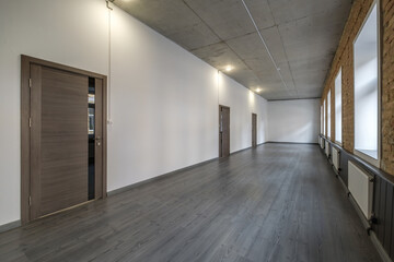 long white empty corridor in interior of entrance hall of modern apartments, office or clinic