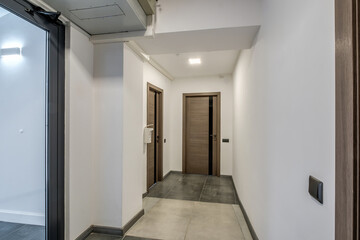 long white empty corridor in interior of entrance hall of modern apartments, office or clinic