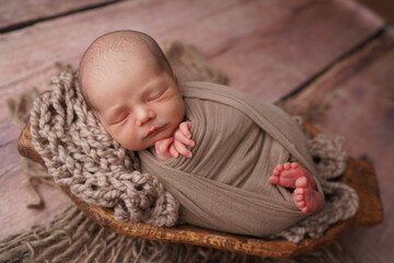 Sleeping newborn boy in the first days of life. Newborn photo session.