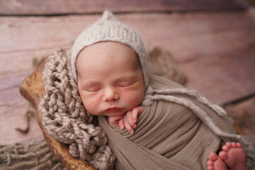 Sleeping newborn boy in the first days of life. Newborn photo session.