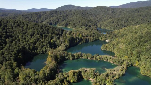 Flying over the famous Plitvice Lakes with forest at summer in Croatia, Central Europe, travel and nature concept