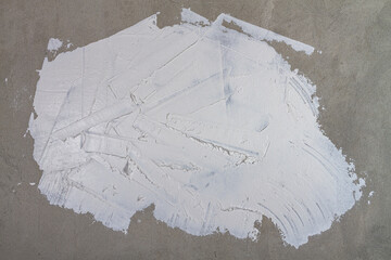 The background is made of a wall plastered with white putty with irregularities, smudges and...
