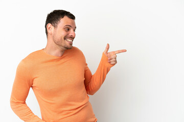 Brazilian man over isolated white background pointing finger to the side and presenting a product