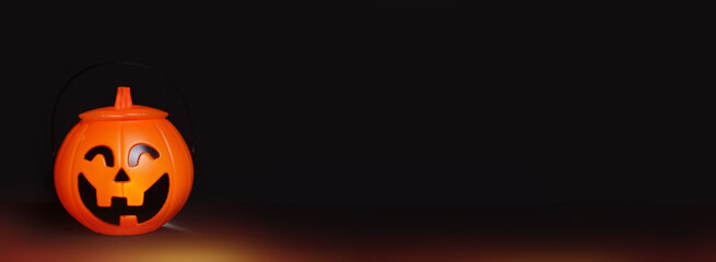 Glowing Halloween handbag in the form of a pumpkin on a black background.Halloween trick or treat!?opy space for text. Banner