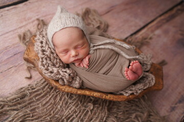 Sleeping newborn boy in the first days of life. Newborn photo session.