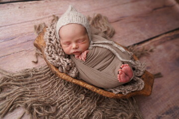 Sleeping newborn boy in the first days of life. Newborn photo session.