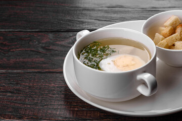 Asian noodle soup, ramen with chicken, vegetables and egg in white bowl