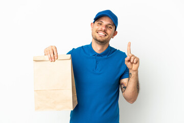 Brazilian taking a bag of takeaway food isolated on white background showing and lifting a finger in sign of the best