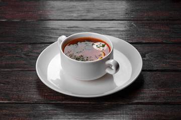 Appetizing dish of russian hodgepodge soup in ceramic pot