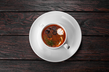 Appetizing dish of russian hodgepodge soup in ceramic pot