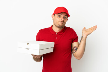 pizza delivery man with work uniform picking up pizza boxes over isolated  white wall having doubts...
