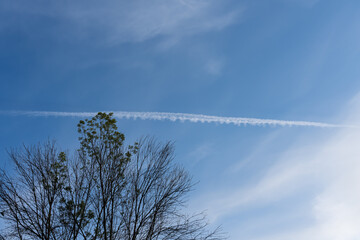 Trail from a flying plane in the sky