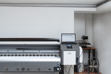 large format plotter with a laptop on top. impression concept.