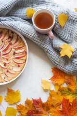Apple pie layout and autumn leaves top view . An article about autumn. An article about baking. Homemade cakes.
