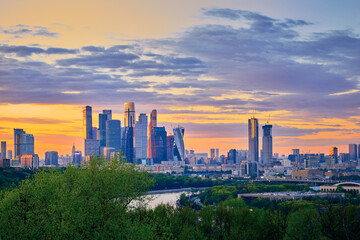 Fototapeta premium Urban landscape panorama of Moscow with Moscow-city downtown business center with tall buildings in sunset. Moscow. Russia.