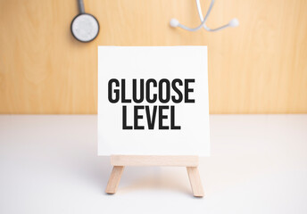 Glucose Level sign on small wood board rest on the easel with medical stethoscope
