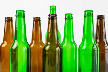 Empty beer or beverage bottles on white surface. Reuse and recycling of glass. Waste.
