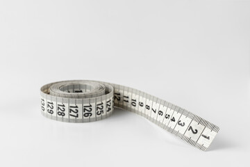 soft two sided tape measure roll isolated on a white and gray background with copy space