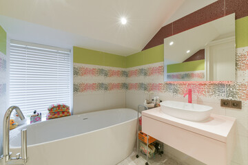Bright kids bathroom with bathtub and sink