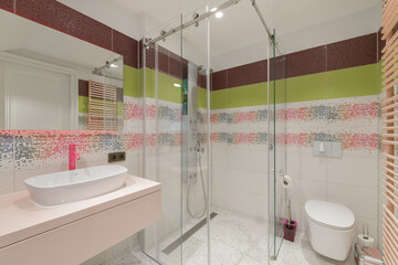 Modern kids bathroom with shower cabin, sink and toilet