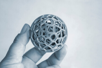 Person holding object printed on powder 3D printer from powder polyamide