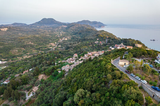 Sunset over coast of Corfu with Pelekas village, Greece.