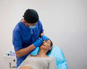 Surgeon drawing line on girl eye with marker preparing for procedure.