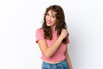 Young woman with curly hair isolated on white background celebrating a victory