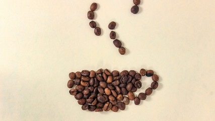 The roasted coffee beans move into the shape of a mug and steam from the drink.