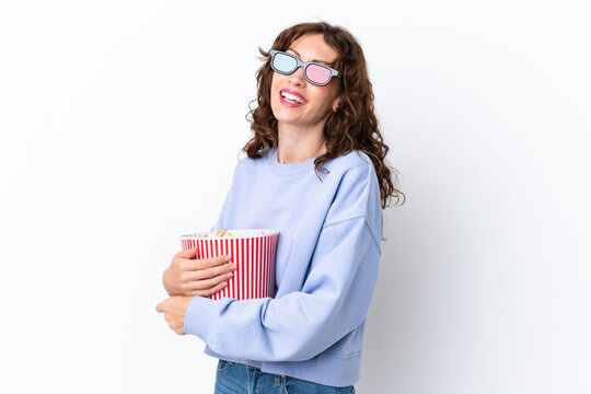 Young woman with curly hair isolated on white background with 3d glasses and holding a big bucket of popcorns