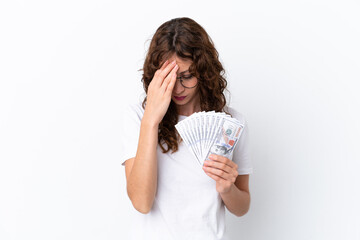Young woman with curly hair taking a lot of money isolated background on white background with tired and sick expression