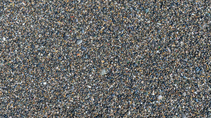 sea beach of small multi-colored pebbles as a natural background
