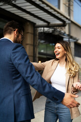 Young businesswoman and businessman standing on the street Beautiful businesswoman talking with her colleague..