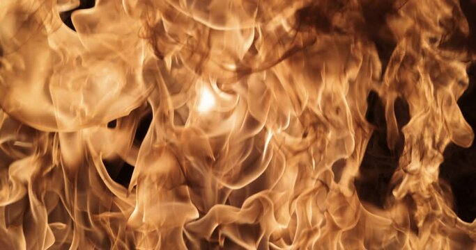 Close-up of the fire on a black background. Fire in slow motion in full screen.