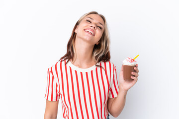 Young Russian girl holding cappuccino isolated on white background laughing