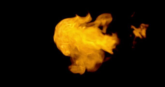 A slow-motion shot of fire breath flames on a black background.