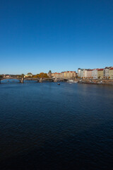 Fototapeta na wymiar La vue sur la rivière Vltava, Moldau, un pont et les bâtiments de Prague.
