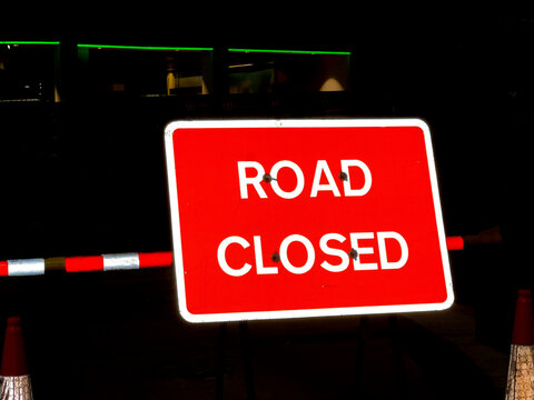 Highly Reflective Road Closed Sign At Night In A City Centre. No People.