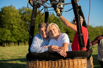 Adventure love couple on hot air balloon. Man and woman love each other. Burner directing flame into. Preparing for the flight. instructor