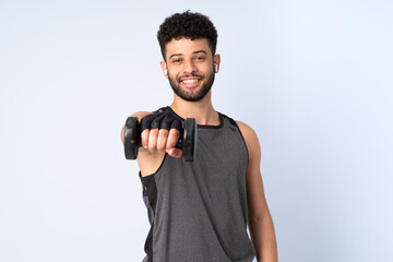 Young Moroccan man isolated on blue background making weightlifting